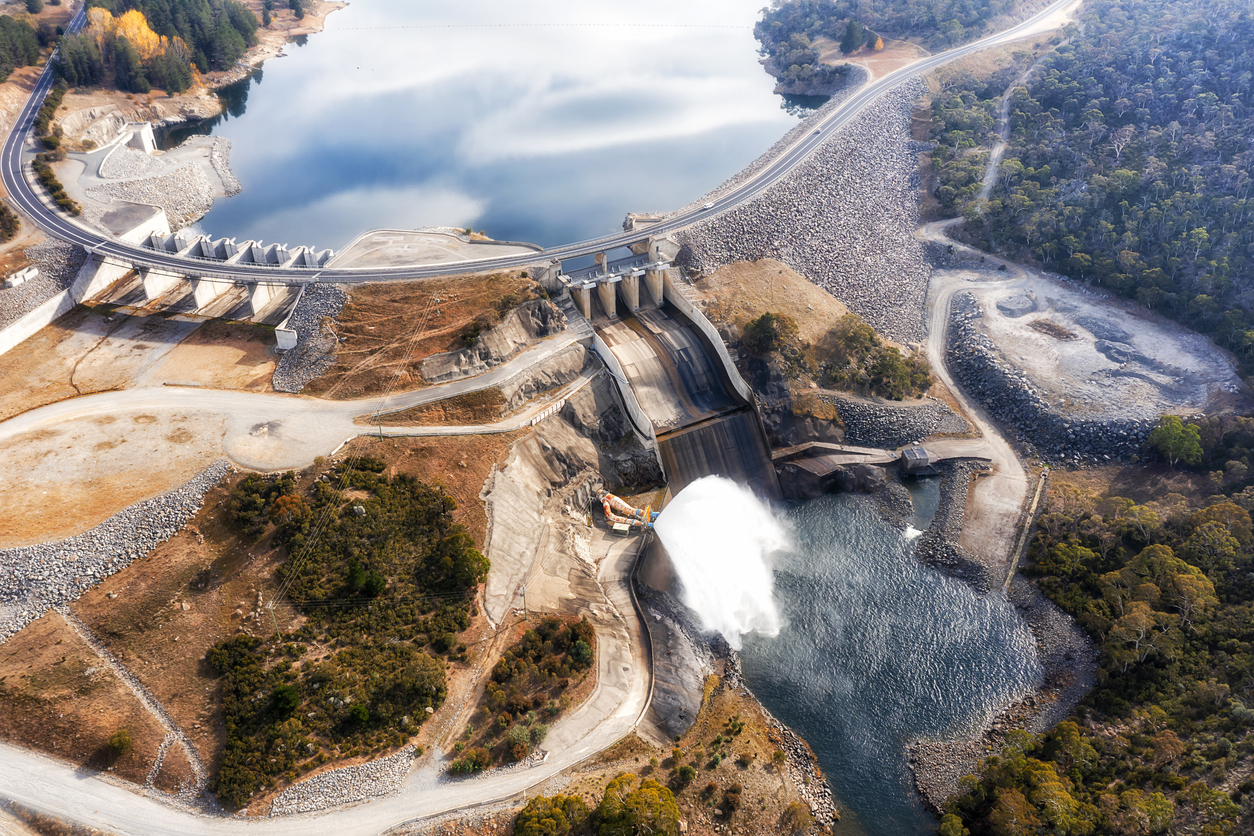 Spillway and shutter gate of Jindabyne dam on Snowy River in Australian SNowy Mountains - aerial view.